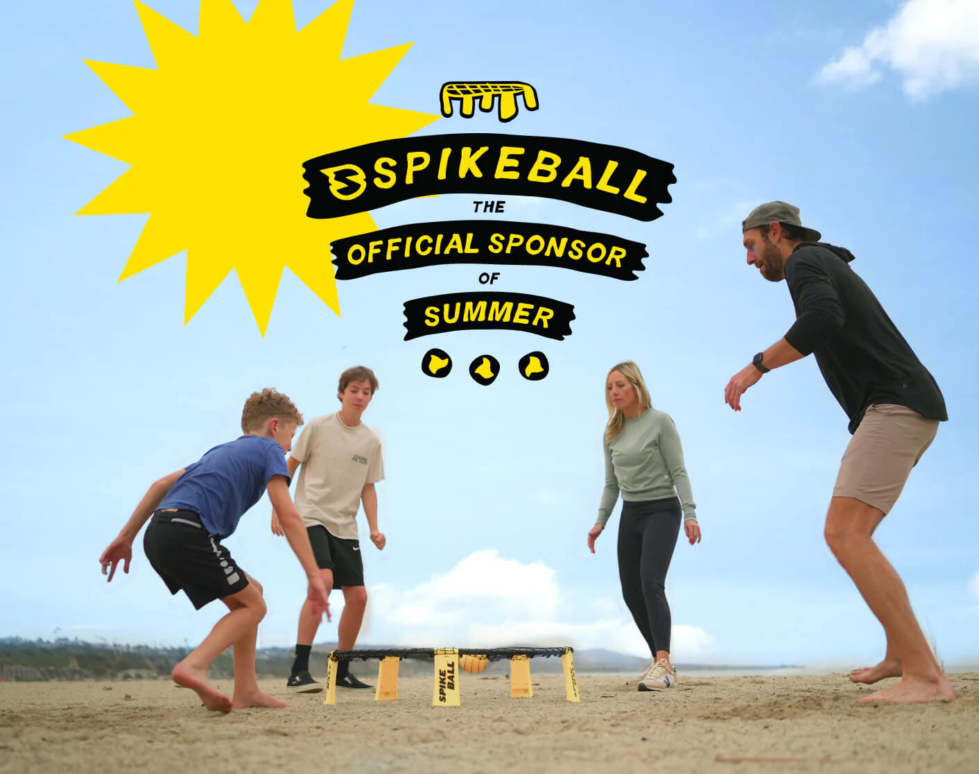 Family playing spikeball at the beach